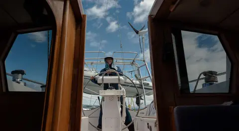 Lesley at the helm running downwind up the east coast of bruny