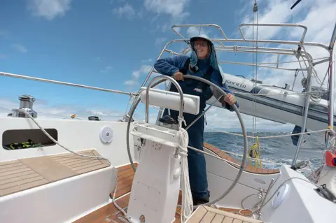 Lesley at the helm running downwind up the east coast of bruny