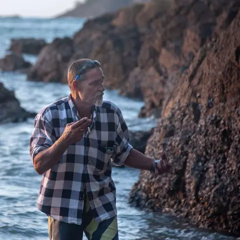 Jimmy. Cigarette in one hand, oyster in the other.