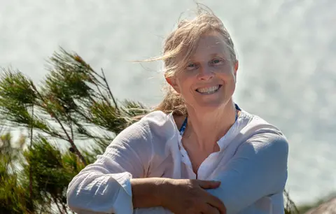 A windblown Lesley. At the summit of Fitzroy Island.