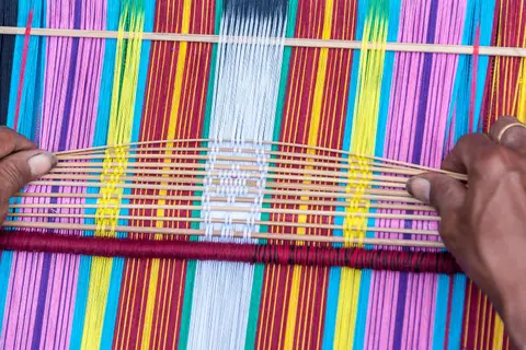 Tais Weaving Loom.. Traditional Tais are hand-woven. Women sit with the loom in front of them and it's slow, back-breaking work.