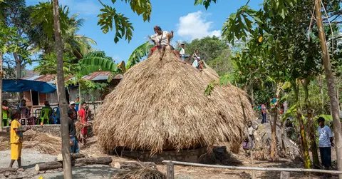 Finished!. These guys just finished putting the roof on this traditional family hut