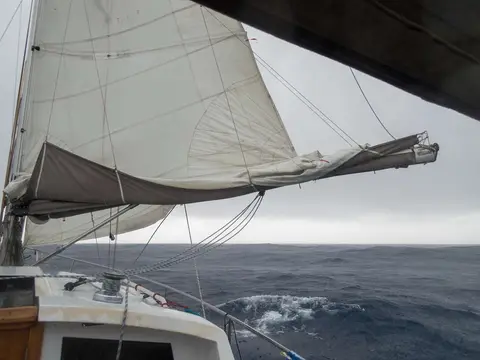 Sail full of rainwater.. The rain was captured by the reefs in the mainsail and the sail bag, distorting the shape and adding a lot of weight.