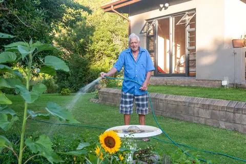Walter. Watering the garden at home. Water is restricted so garden water comes from tanks.