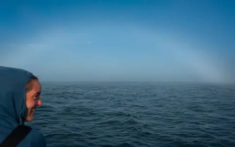 Fogbow. As we approach the coast the fog parts and we can look back at it.