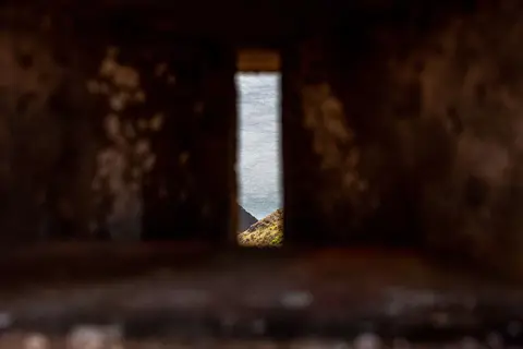 Embrasure. You stick your gun thru the slit and hope the guys on the other side don't see your muzzle flash.