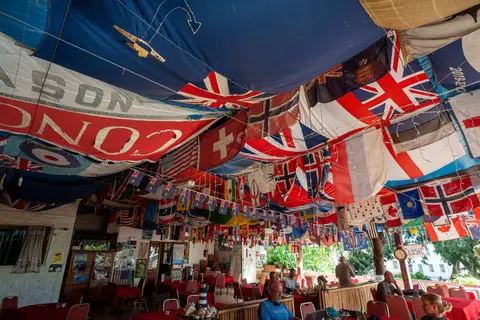 Anne's Cafe. Anne is gone, but the flags live on. Anne died some years back but it's still the place yachties congregate.