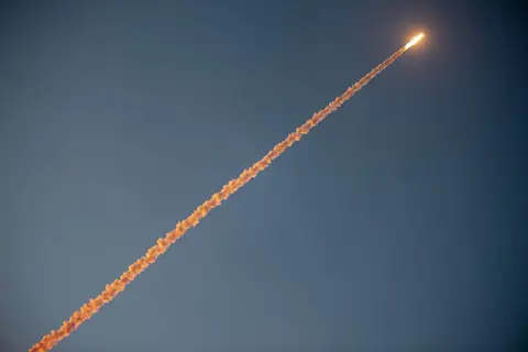 And Away. The vapour trail glows in the setting sun