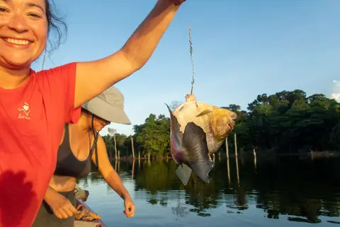 Ida catches piranha any way she can!
