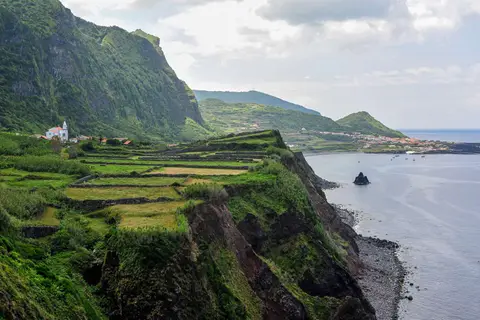 Fajaa Grande. A fajaa is a flat stretch of land at the base of a cliff. The village of Fajaa Grande is in the distance.