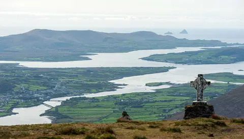 The Skelligs. Cahersiveen is in the valley on the far side of The Fertha. You can see the marina at the right of the town. Valentia is the big island above the cross and the Skelligs are visible just below the horizon.
