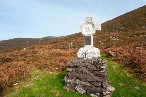 Simon helps Jesus. It's a pilgrim trail and each cross celebrates a moment of Jesus' crucifixion.