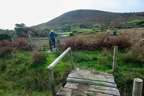 Stiles and Gates. The trail is thru pasture lands.