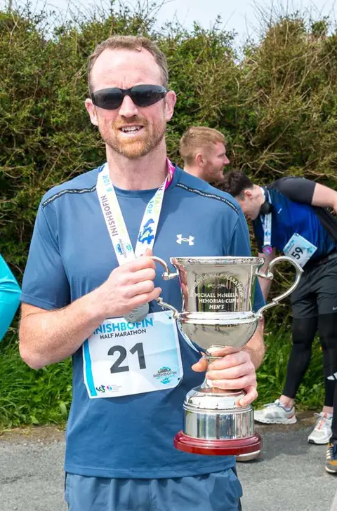 Winners Can Be Grinners.. Well he is trying to grin.