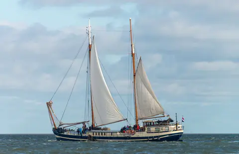 Mermaid. Flat-bottomed with gigantic lee boards instead of a keel.